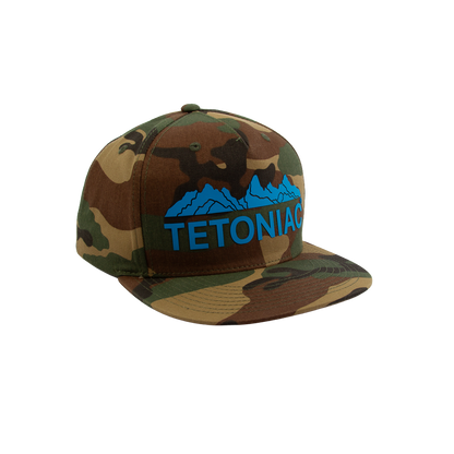PAKO DESIGNS - TETONIAC® 5 PANEL FLAT BILL TWILL TRUCKER HAT - WOODLAND CAMO / MALIBU BLUE SILICONE