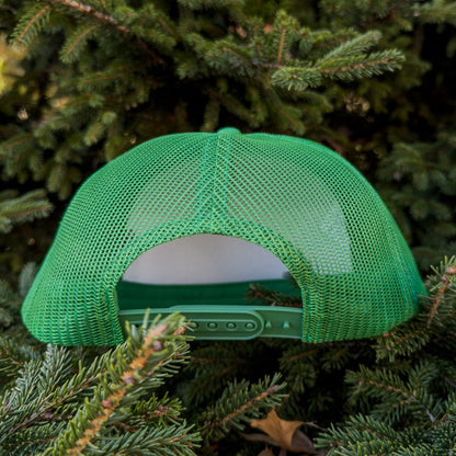 Green mesh cap on a background of green foliage
